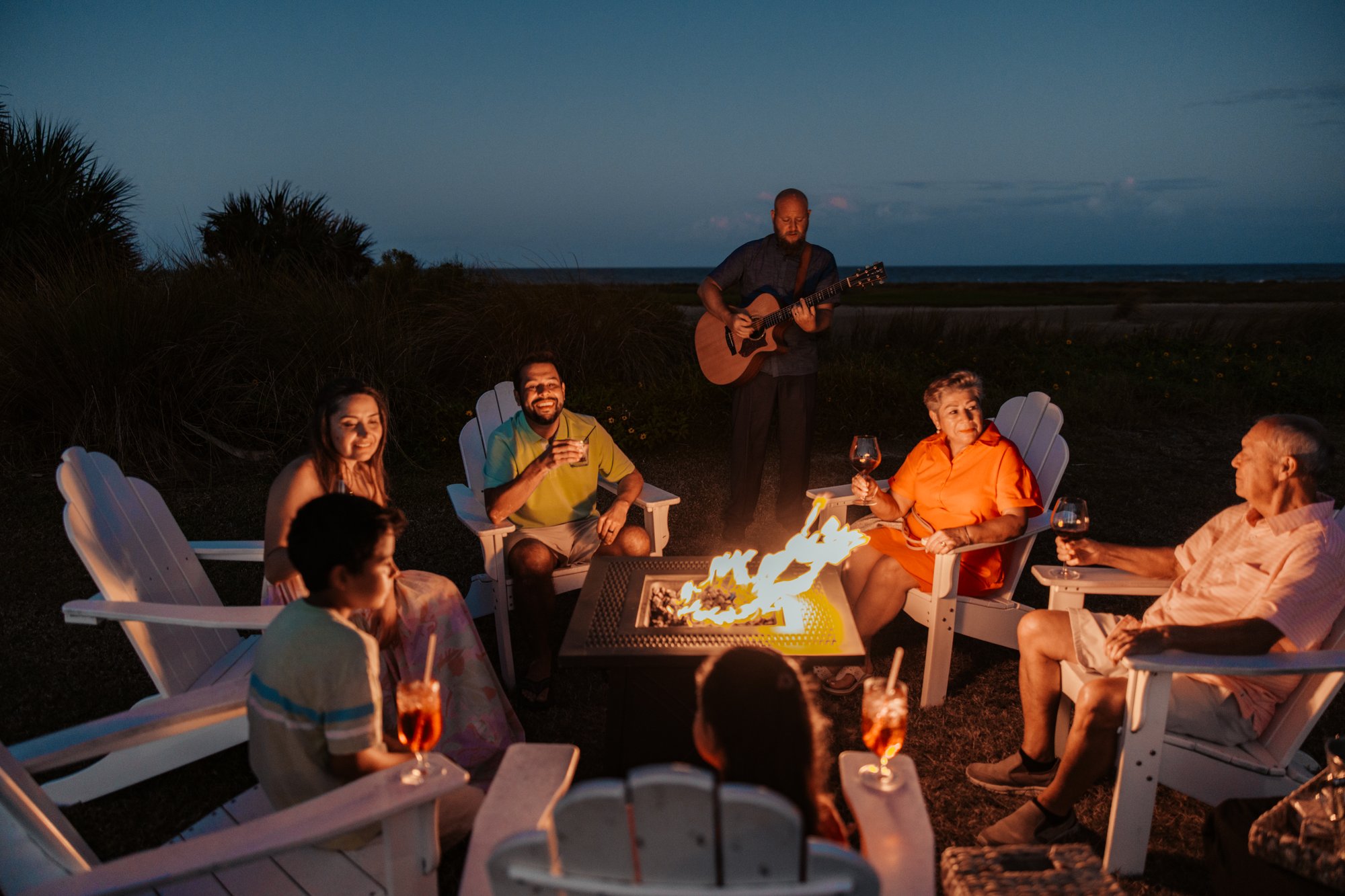 Palm Coast - Hammock Beach Resort - Multi-Gen Family Enjoying Treats Around Fire Pit with Musician-C - 2024 (Emergent)